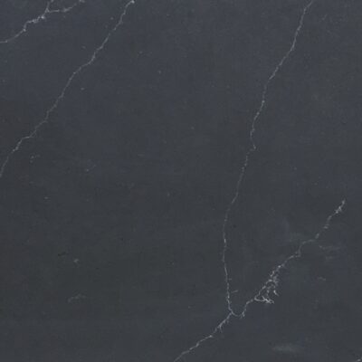 Dark gray stone surface with subtle white veining running diagonally across the image.