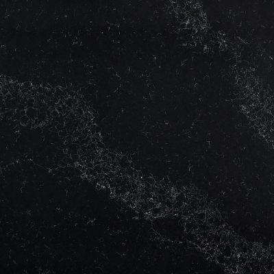 Black marble surface with subtle white veining and a textured, natural stone appearance.