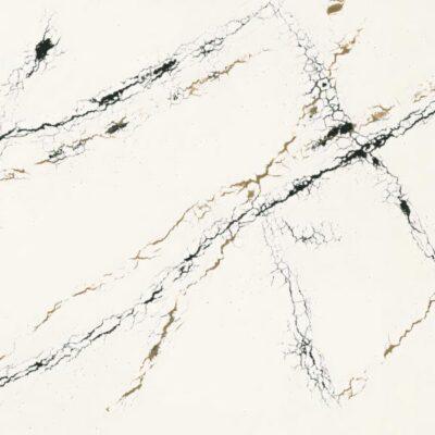 White marble surface with thin black and gold veining running diagonally across the stone.