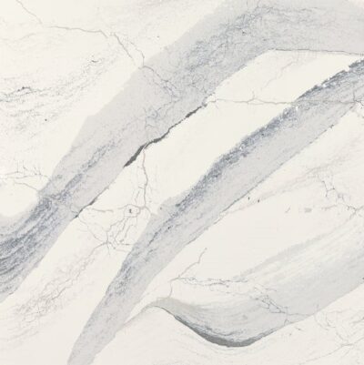 White marble surface with gray veining and abstract, wavy streaks running diagonally across the image.