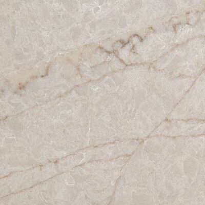 Light beige marble surface with subtle brown and tan veins running diagonally across the stone.