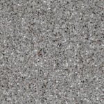 Close-up of a speckled gray granite surface with black, white, and brown mineral flecks throughout.