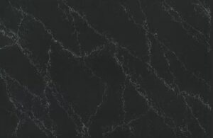 Black marble surface with thin white veining patterns running across it.