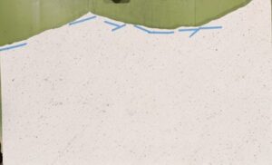 Green shape on top, wavy blue lines below, and a large white speckled area fills most of the image.